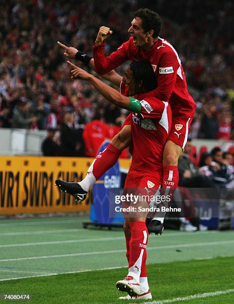 Fernando Meira of Stuttgart celebrates with his team mate Roberto Hilbert after scoring the opneing goal during the Bundesliga match between VfB...