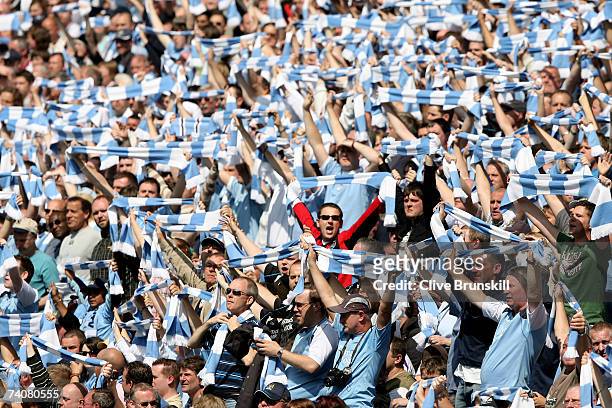 Manchester City fans sing during the Barclays Premiership match between Manchester City and Manchester United at the City of Manchester Stadium on...