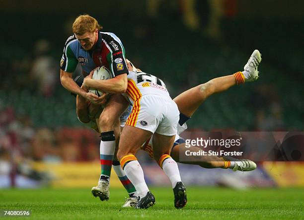 Jon Grayson of Harlequins charges through the Catalans tacklers during the Engage Super League match between Catalans Dragons and Harlequins RL at...