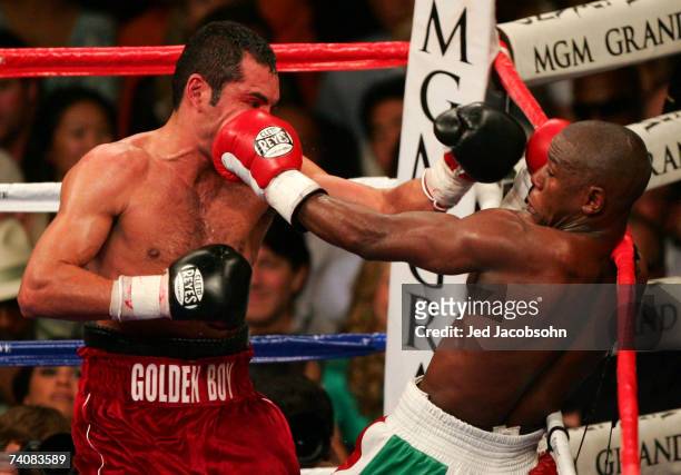 Oscar De La Hoya throws a right at Floyd Mayweather Jr. During their WBC super welterweight world championship fight at the MGM Grand Garden Arena...