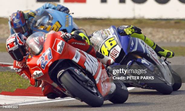 Australian MotoGP rider Casey Stoner leads seven-time world champion Valentino Rossi of Italy and John Hopkins of the US during the Grand Prix of...