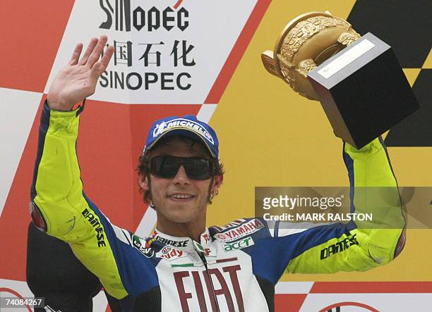 Italian MotoGP rider Valentino Rossi from the Yamaha Team celebrates on the podium after finishing second in the MotoGP race at the Grand Prix of...