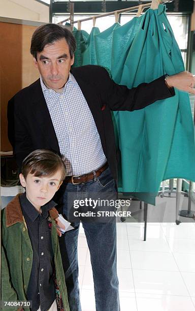 Francois Fillon, former French minister and political advisor to Nicolas Sarkozy, next to his son Arnaud, exits a booth prior casting his ballot at a...