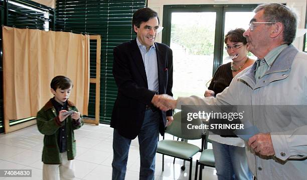 Former French minister and political advisor to Nicolas Sarkozy, Francois Fillon, next to his son Arnaud, arrives in a polling station before voting,...