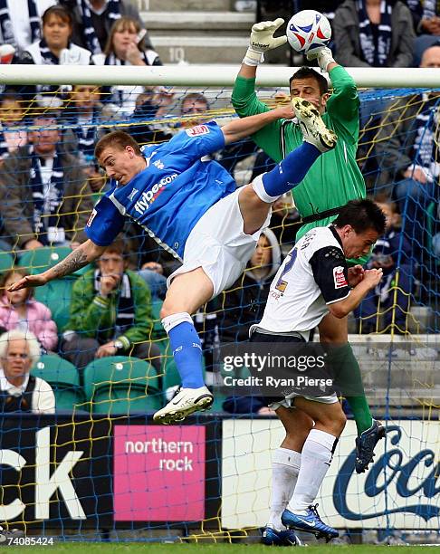 Niklas Bendtner of Birmingham City flies across the front of Wayne Henderson of Preston North End during the Coca Cola Championship match between...