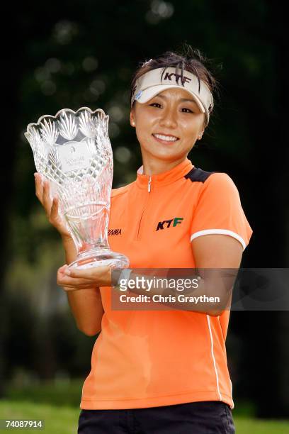 Mi Hyun Kim of South Korea holds the winner's trophy after beating Juli Inkster in a playoff during the final round of the SemGroup Championship...