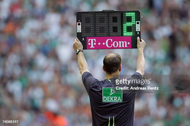 The fourth referee holds a board that shows two minutes extra time during the Bundesliga match between Hertha BSC Berlin and Werder Bremen at the...