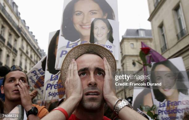Supporters of Socialist presidential candidate Segolene Royal react after the announcement of the first unofficial results of the French presidential...