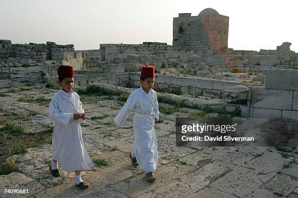Young boys from the ancient Samaritan sect walk through the ruins of a Byzantine church after dawn prayers on the last day of their Passover...