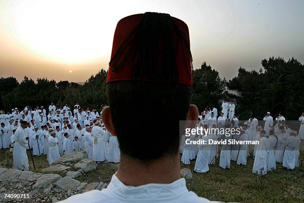 Men from the ancient Samaritan sect hold prayers at dawn on the last day of their Passover celebrations on top of Mount Gerizim May 7, 2007 near the...