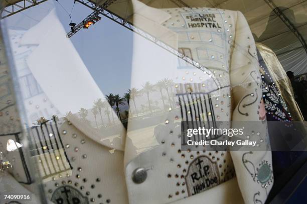 The Indio treeline is reflected off a glass case housing an original Nudie's cowboy suit at the Honky Tonk Museum in the Mustang Stage at the...
