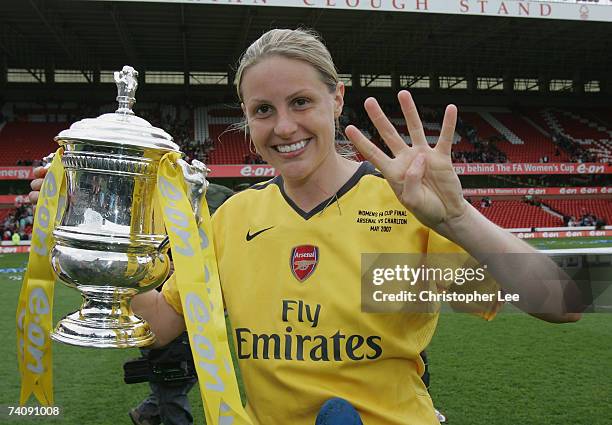 Kelly Smith of Arsenal celebrates with the trophy and signs the number four, for them winning the Quadruple this year, during the FA Womens Cup final...