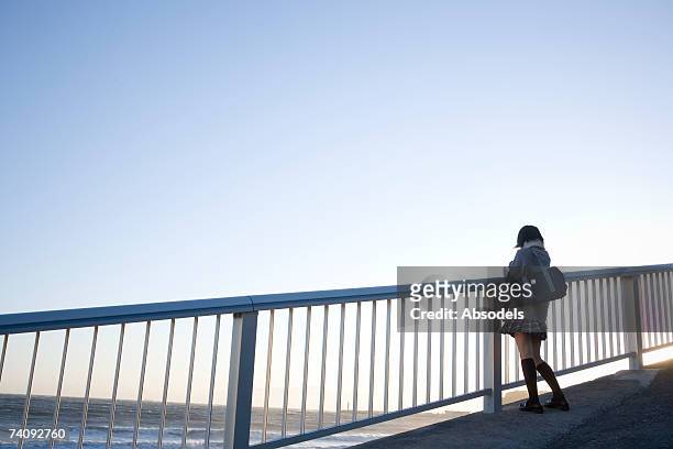 a girl looking at the sea - female looking away from camera serious thinking outside natural stock pictures, royalty-free photos & images