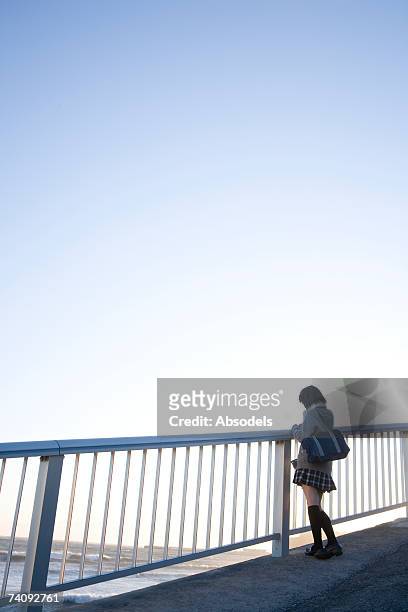 a girl looking at the sea - female looking away from camera serious thinking outside natural stock pictures, royalty-free photos & images