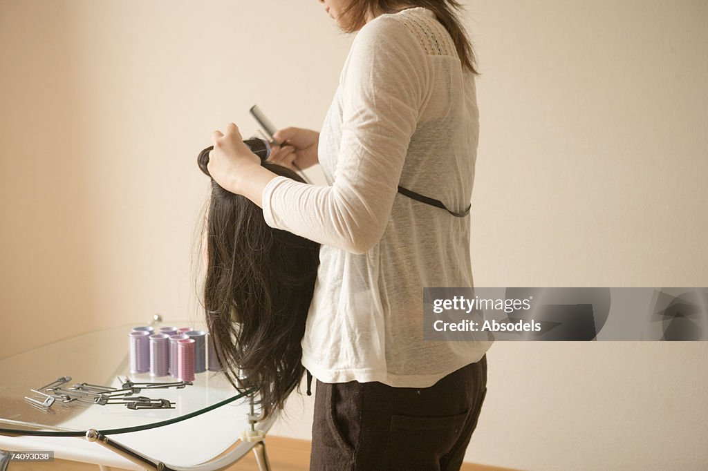 Young woman practicing hair dressing