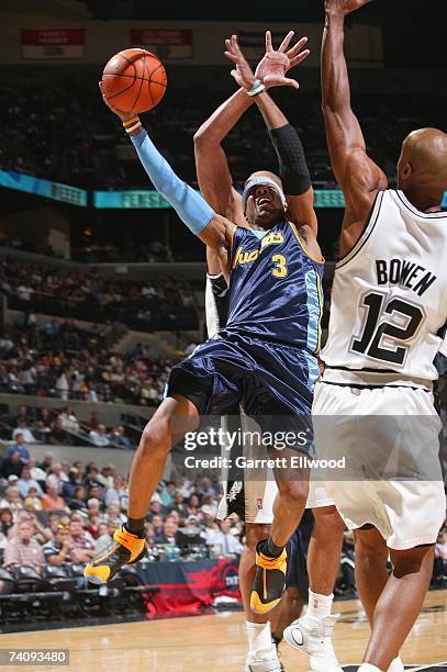 Allen Iverson of the Denver Nuggets goes to the basket against Bruce Bowen of the San Antonio Spurs in Game Two of the Western Conference...