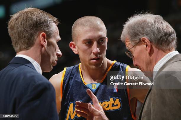 Steve Blake, center, talks to assistant coaches Mike Dunlap, left, and Tim Grgurich, right, of the Denver Nuggets in Game Two of the Western...