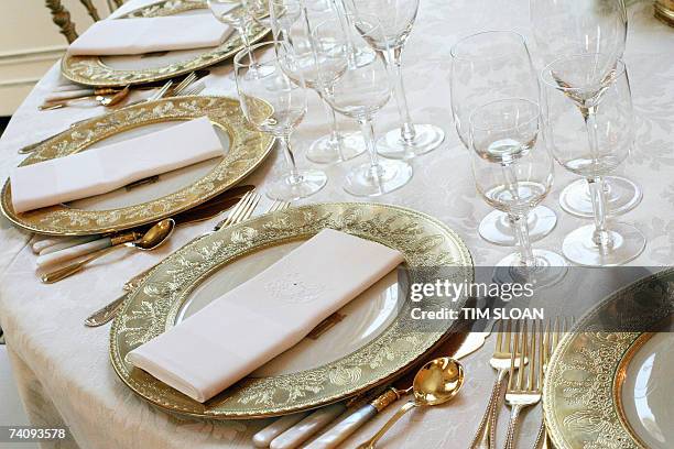 Washington, UNITED STATES: A table setting is shown during a press preview of the State dinner for Queen Elizabeth II of England and her husband...