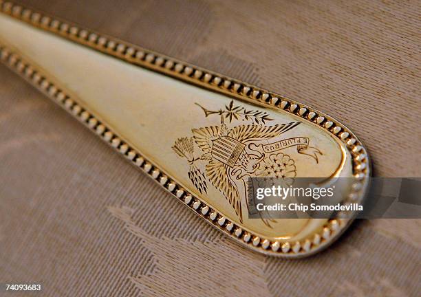 Silverwear etched with the presidential seal sits at the place settings for Queen Elizabeth II in advance of the state dinner in her honor in the...