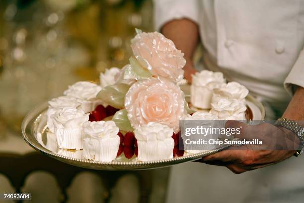 Sweet candy "rose blossoms" will be served for dessert during the dinner honoring Queen Elizabeth II in the State Dining room on the State Floor of...