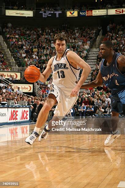 Mehmet Okur of the Utah Jazz drives against Antawn Jamison of the Washington Wizards at EnergySolutions Arena on March 26, 2007 in Salt Lake City,...