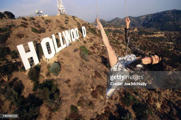 Actress Michelle Yeoh in mid-air over the famous Hollywood sign in November 1998 in Los Angeles, California