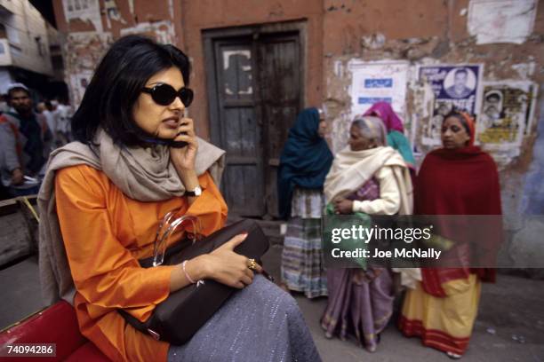 Sophisticated Indian woman rides through the streets in January of 1999 on her cellphone in New Delhi, India. The Indus Valley civilization, from...