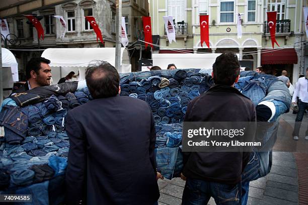 Turkish men cary a couch made of Jeans of the Turkish jeans company of Mavi at the GaataModa festival on May 05, 2007 in Istanbul, Turkey. Modern...