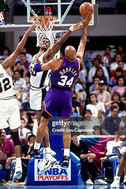 Charles Barkley of the Phoenix Suns shoots against David Robinson of the San Antonio Spurs during Game Four of the Western Conference Semifinals...