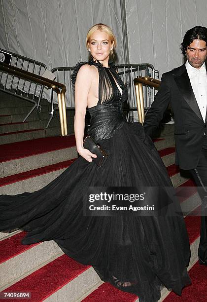 Actress Lindsay Lohan and show designer Brian Atwood leave The Metropolitan Museum of Art's Costume Institute Gala May 7, 2007 in New York City.