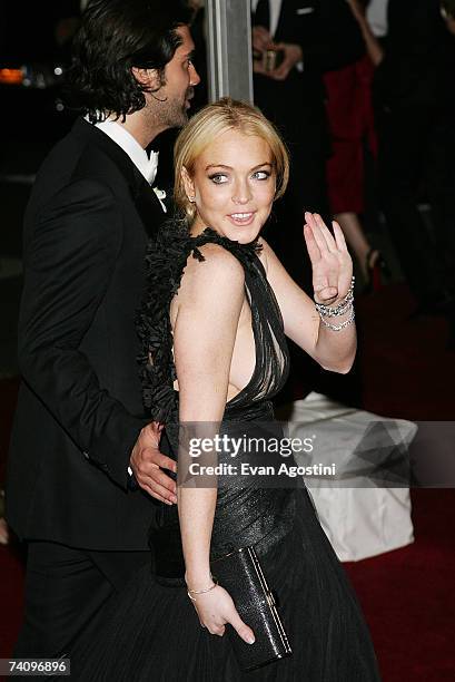 Actress Lindsay Lohan and show designer Brian Atwood leave The Metropolitan Museum of Art's Costume Institute Gala May 7, 2007 in New York City.