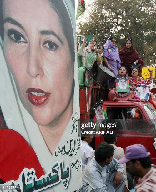 Activists of Pakistan People's Party shout slogans as they hold pictures of former prime minister Benazir Bhutto during a demonstration in Lahore, 05...