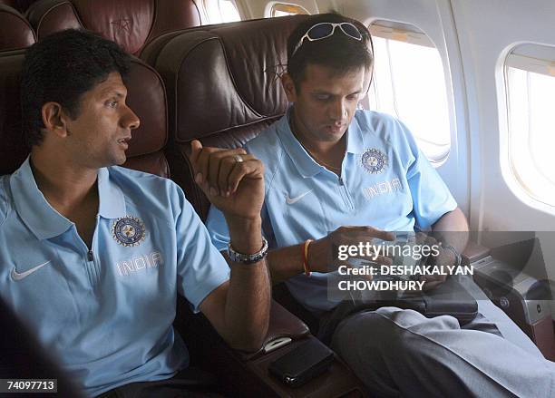 Indian cricket team captain Rahul Dravid and bowling coach Venkatesh Prasad share a moment onboard a flight to Bangladesh after they left India in...