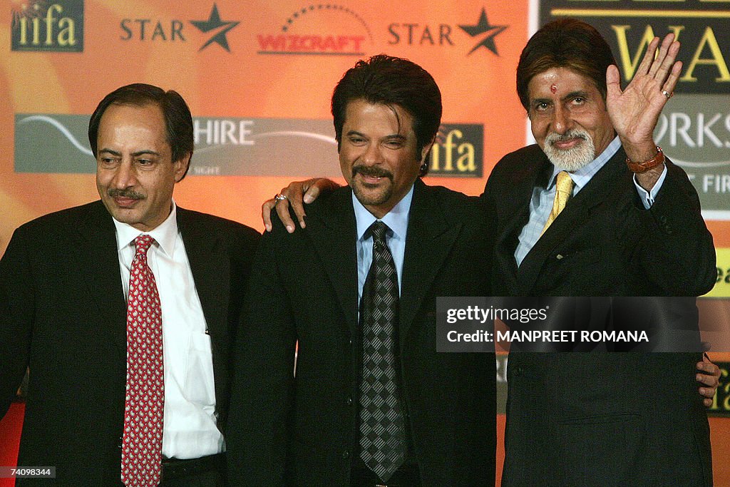 Indian actor Amitabh Bachchan (R) waves...