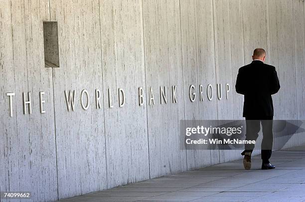 An employee walks outside the World Bank headquarters May 8, 2007 in Washington, DC. Recent reports indicate that the global financial institution...