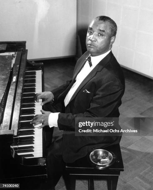 Jazz pianist Little Brother Montgomery poses for a circa 1950 portrait playing piano in a studio.
