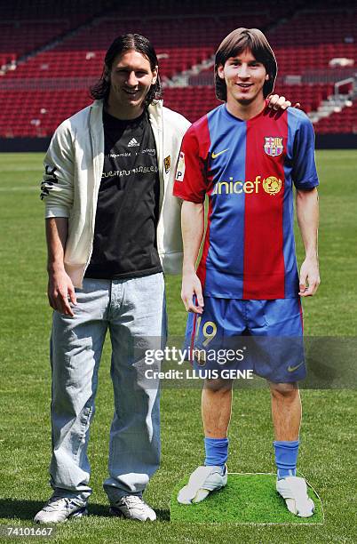 Barcelona's Argentinian Leo Messi poses with his portrait at Camp Nou stadium, 19 April 2007, in Barcelona. Messi scored yesterday against Getafe a...