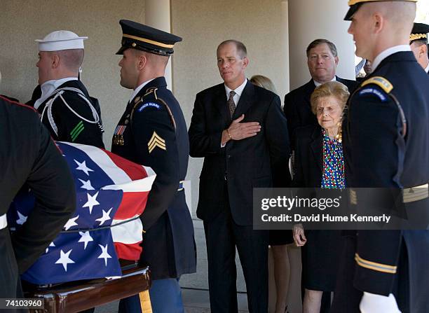 Former First Lady Betty Ford with sons Steve Ford and Jack Ford behind her, watch the casket bearing former President Gerald R. Ford into a prayer...