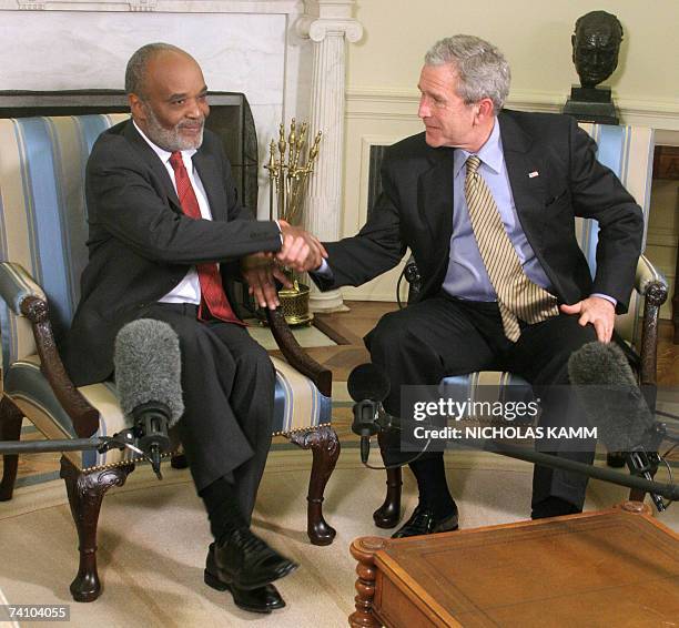 Washington, UNITED STATES: US President George W. Bush shakes hands with his Haitian counterpart Rene Preval in the Oval Office at the White House in...