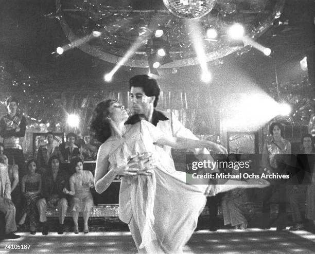 Actor John Travolta dances with Karen Lynn Gorney in scene from movie "Saturday Night Fever" directed by John Badham.