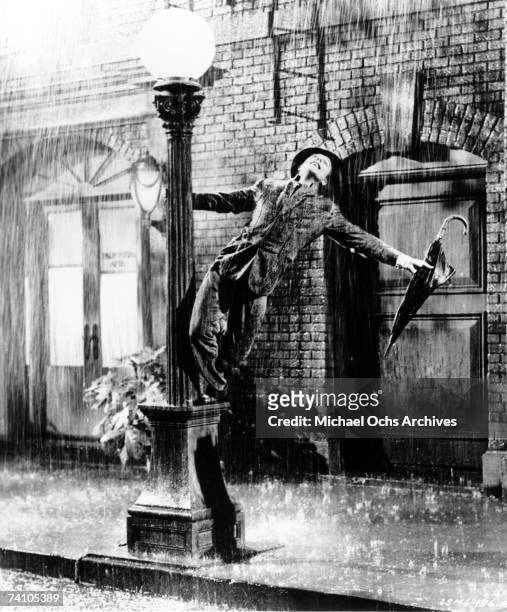 Actor Gene Kelly performs song "Singin' In The Rain" from movie of same name. "Singin' In The Rain" was directed by Stanley Donan and Gene Kelly.
