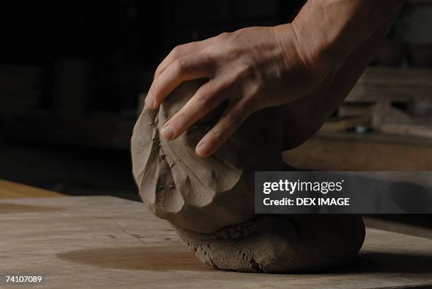 close-up of a person's hands kneading mud - knåda bildbanksfoton och bilder
