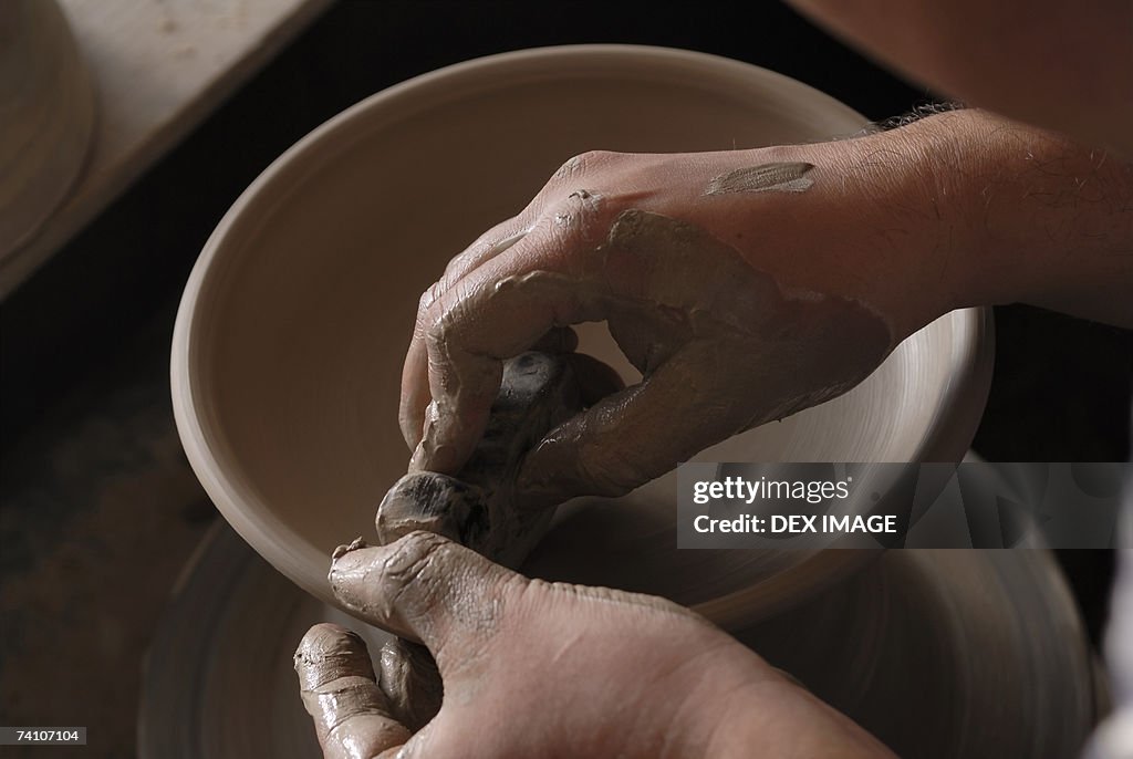 Close-up of a potter's hands making pottery