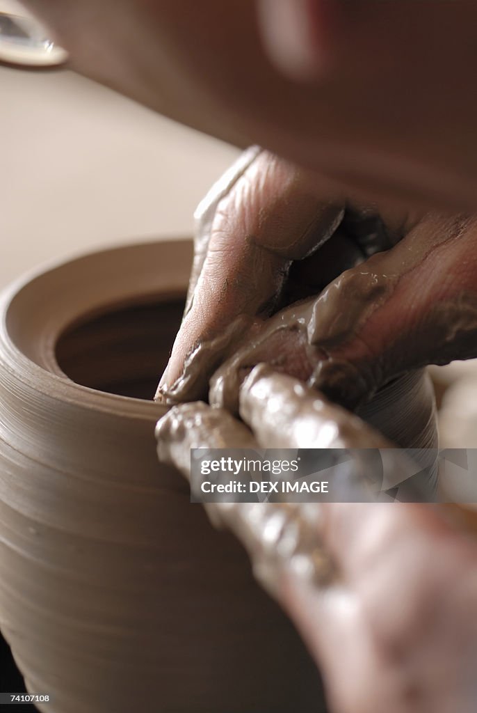 Close-up of a potter's hands making a vase