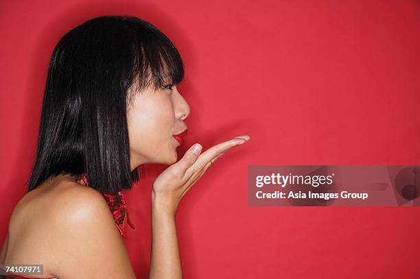 woman with bob haircut, blowing a kiss, side view - ストレートヘア ストックフォトと画像