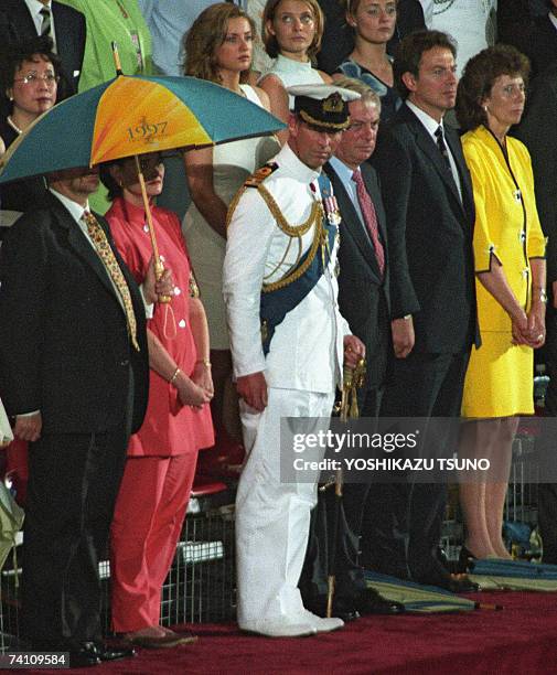 Britain's Prince Charles watches the British Military Farewell Ceremony at the HMS Tamar military base in Hong Kong, 30 June 1997, marking the end of...