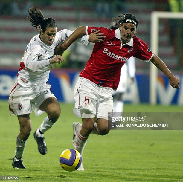 Leonard Pajoy of Cucuta from Colombia fights for the ball with Toluca's Javier Rosada of Mexico during their Libertadores Cup soccer match in Toluca...