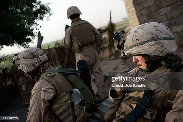 Marines Private First Class Cameron Smith from Texline, Texas of Echo Company 2 battalion, 7th Marines takes a break with his squad during a local...