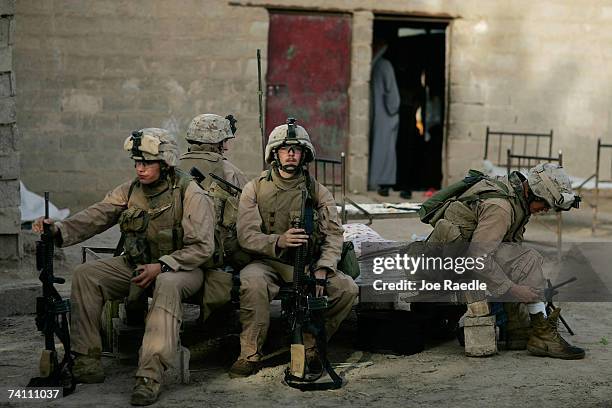 Marines of Echo Company 2 battalion, 7th Marines take a break during a local security patrol May 9, 2007 in the area known as Zaidon in the An Bar...