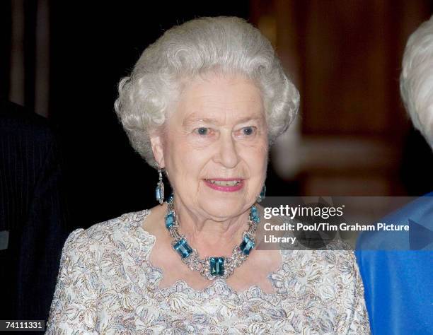 Queen Elizabeth II arrives at the British Ambassador's Residence for a dinner on the final day of her USA tour wearing an Aquamarine and diamond...